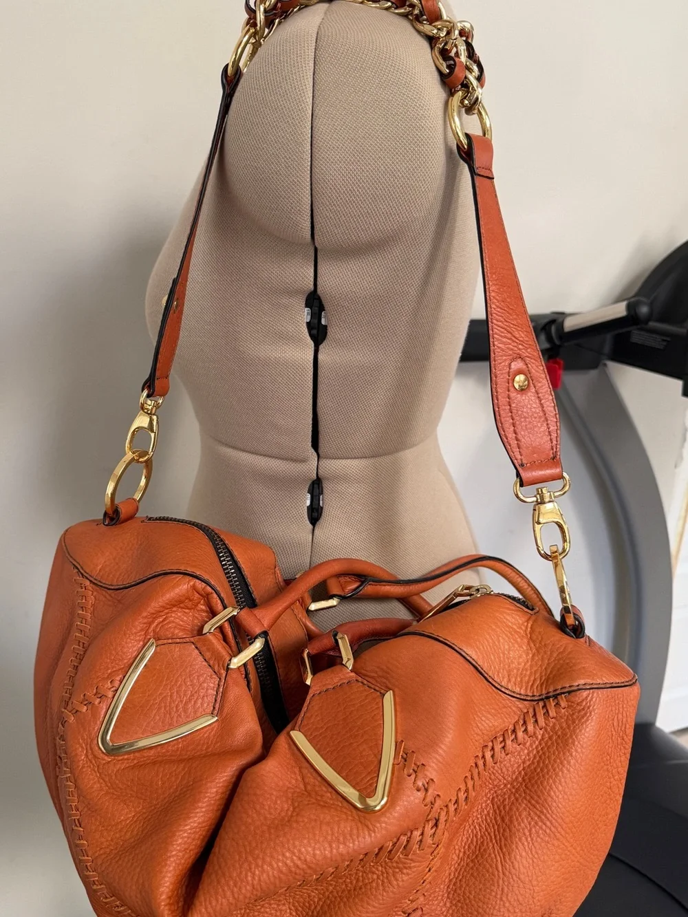 Orange leather handbag appears to be a slouchy style by orYany